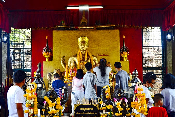 Fieles buda dorado adornos flores templo Phra Kan Shrine Lopburi
