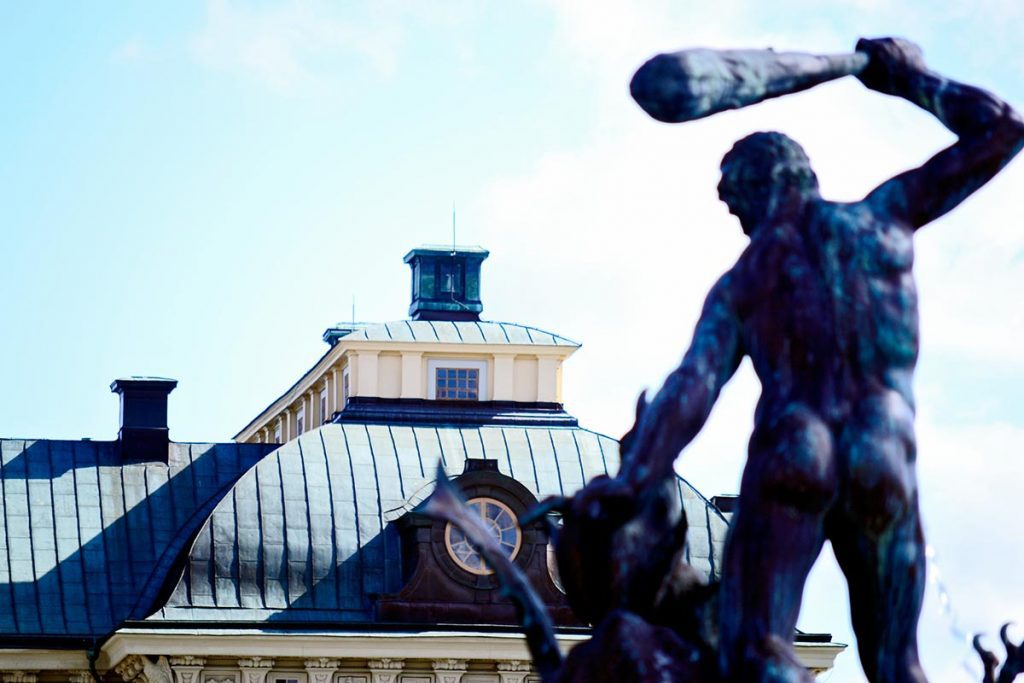 Escultura Hércules garrote espaldas tejados palacio Drottningholm Suecia